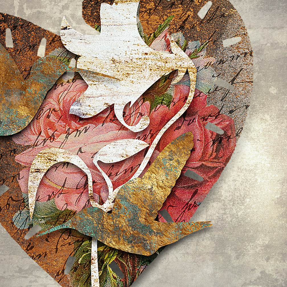 Closeup of Love Hummingbirds Dimensional Metal Wall Décor by Ralph Burch. Pictured is a metal layered Heart shaped background with florals and handwriting and weathered rusty tones. Attached to the hearts is rustic white Lilly shape and on top of that are 2 hummingbird shapes in goldish tones and blueish green tones.