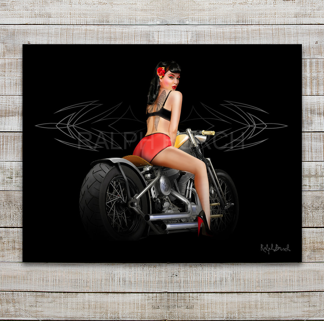 Pin Up Girl "Angel Baby with Tattooed Wings on her back" on a Bobber Motorcycle Wall Art. Pictured is a painting with a Black background with a light pinstripe. Featured is a Retro Pin Up Girl Ralph Call Angel Baby as her back is tattooed  with Angel Wings.  She is sitting on a Bobber Motorcycle. 