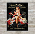 Vintage Fast Lane Recording Studios by Ralph Burch Wall Art. Pictured is A Retro Redheaded Pin Up Girl with a ponytail. She's sitting on crossed guitars. One has flames and the other is like the fin of a 1957 Caddy. The background is black and behind her is a 45 rpm record. There's some pinstriping  and shes holding a microphone and stand. Above her it says Fast Lane Recording Studios and below her it say Where Legends are Born.
