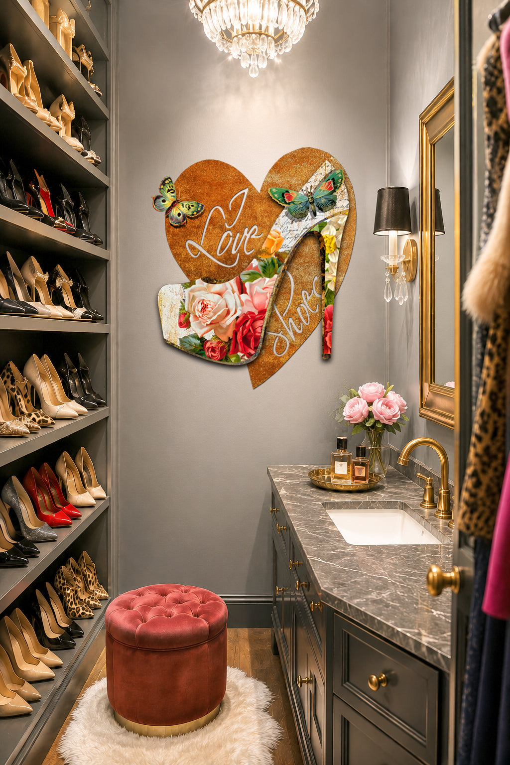 A styled home entryway or dressing area with gray walls, built-in shoe shelves on the left, a marble vanity with gold fixtures, a pink tufted ottoman, and a large decorative heart-shaped wall art piece featuring floral details and the words 'Love Love'.