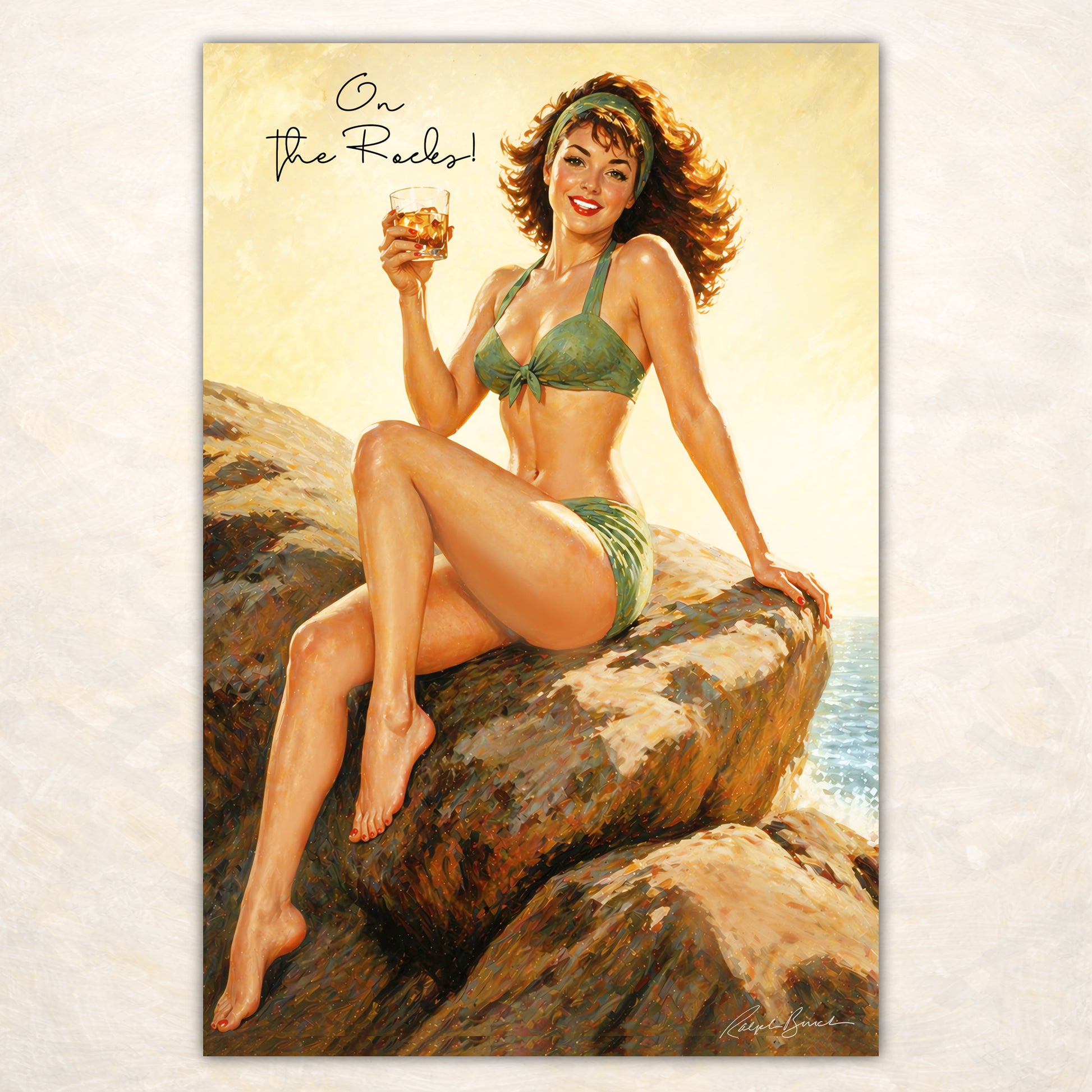 Retro beach pin-up girl holding whiskey cocktail while sitting on ocean rocks in vintage coastal wall art by Ralph Burch