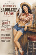 Vintage-style illustrated poster for Ferguson's Saddle Up Saloon, showing a smiling woman in a cowboy hat, plaid shirt, denim shorts, and cowboy boots leaning on a bar counter and holding a beer bottle. Large western text appears on the left, with a stool on the right.